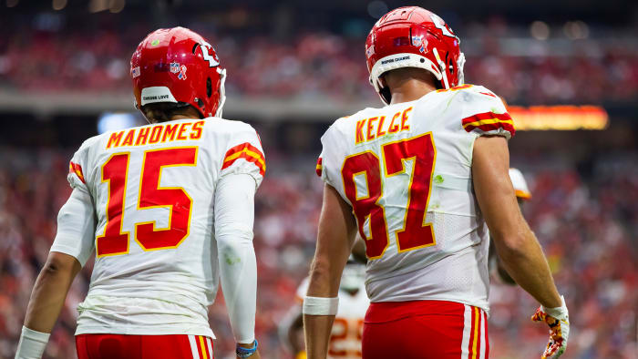 Mahomes and Kelce walk onto the field during a Chiefs game